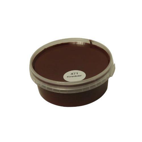 Billedet viser en rund træprøve malet i en dyb, mørkerød Kirsebær farve. Træprøven har en jævn overflade, hvor træets struktur stadig anes gennem malingen. Den runde form anvendes typisk som farveprøve til vurdering af farvens udtryk og dækkeevne på træ. Farven repræsenterer en af de mørkerøde Kirsebær nuancer, som findes i udvalget af heldækkende træbeskyttelse.