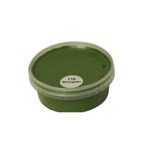 Billedet viser en rund farveprøve bøtte med træbeskyttelse i en dyb mørkegrøn farve. Overfladen fremstår ensartet og dækkende, hvilket giver et klart indtryk af farvens styrke og finish på træ. Farveprøven anvendes til vurdering af farvenuance og dækkeevne inden maling af træværk. Den mørkegrønne farve repræsenterer en af nuancerne i sortimentet af heldækkende træbeskyttelse.