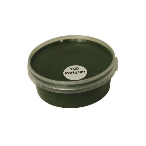 Billedet viser en rund farveprøve bøtte med maling i en ensartet, livlig og klar portgrøn farve. Overfladen fremstår dækkende og jævn, hvilket giver et realistisk indtryk af farvens udtryk på malede overflader. Farveprøven anvendes til at vurdere nuance, dækkeevne og finish før valg af maling til større projekter. Den grønne farve repræsenterer en af de farvenuancer, som findes i udvalget af træbeskyttelse.