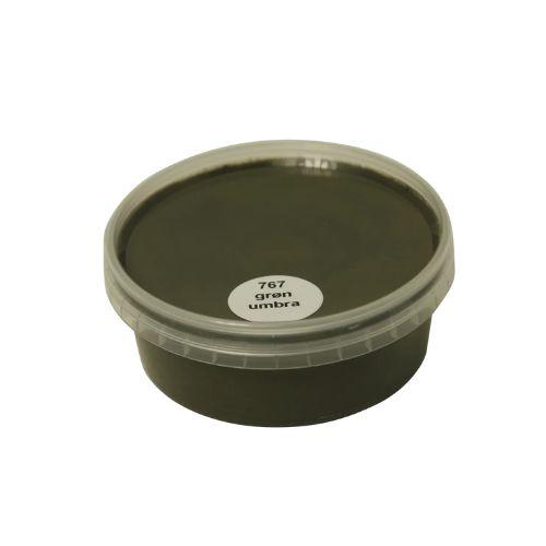 Billedet viser en rund farveprøve bøtte med maling i en ensartet, livlig og klar Grøn Umbra farve. Overfladen fremstår dækkende og jævn, hvilket giver et realistisk indtryk af farvens udtryk på malede overflader. Farveprøven anvendes til at vurdere nuance, dækkeevne og finish før valg af maling til større projekter. Den grønne farve repræsenterer en af de farvenuancer, som findes i udvalget af træbeskyttelse.