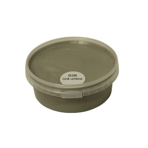 Billedet viser en rund farveprøve bøtte med maling i en ensartet, livlig og klar grå umbra farve. Overfladen fremstår dækkende og jævn, hvilket giver et realistisk indtryk af farvens udtryk på malede overflader. Farveprøven anvendes til at vurdere nuance, dækkeevne og finish før valg af maling til større projekter. Den grønne farve repræsenterer en af de farvenuancer, som findes i udvalget af træbeskyttelse.